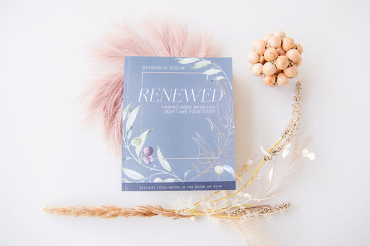 Book titled 'Renewed' with decorative elements on a light background