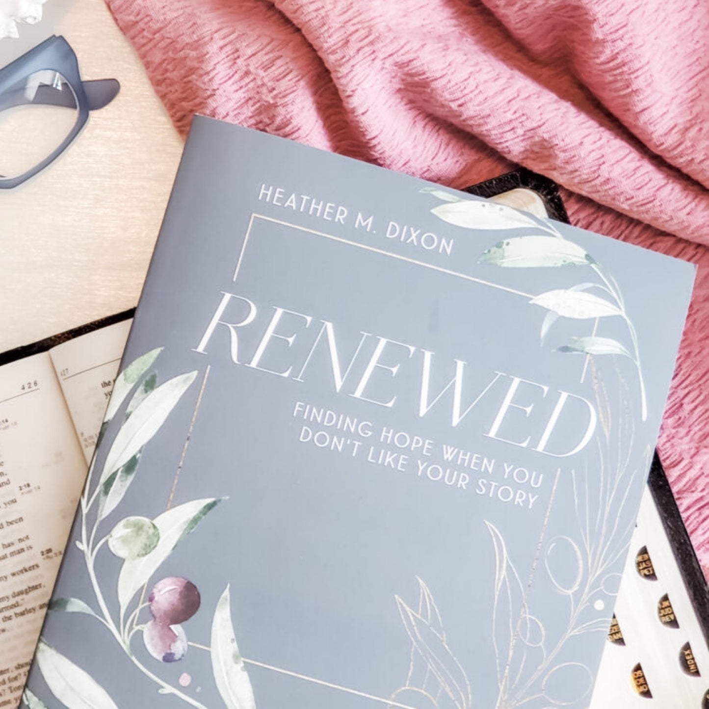 A participant workbook titled 'Renewed' by Heather M. Dixon, featuring a floral design cover with green and gray tones and text.